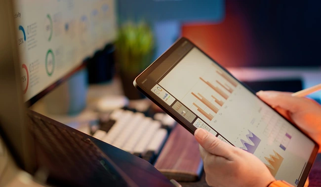 Professional business owner reviewing website analytics and growth metrics on dashboard showing increased sales and customer engagement